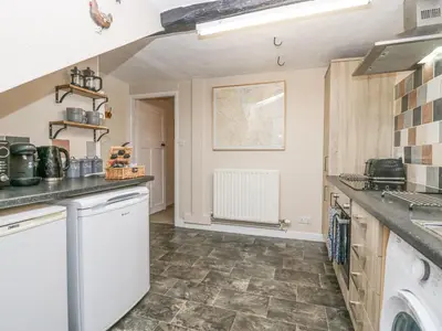 a kitchen with a sink and a dishwasher at Nook Cottage in Keswick