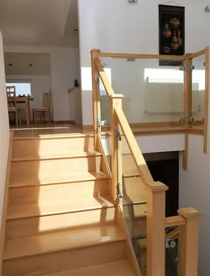 a stairway with wooden steps and a fireplace at Annapurna in Portpatrick