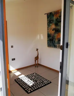 a giraffe standing on a rug in a room at Annapurna in Portpatrick