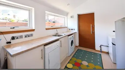a kitchen with a sink and a washing machine at Annapurna in Portpatrick