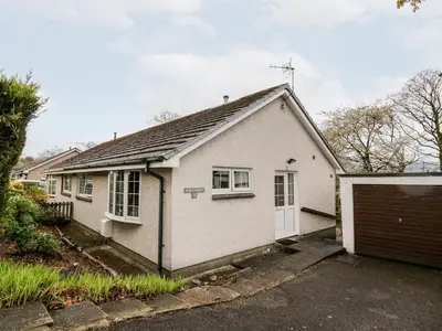 a white house with a garage at Noble Knott in Keswick