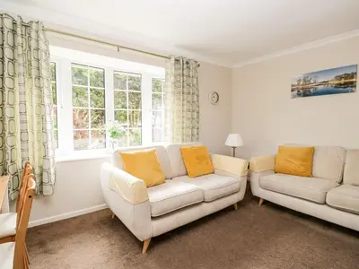 a living room with two couches and a window at Noble Knott in Keswick