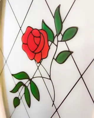 a stained glass window with a red rose at Dumfries Apartment in Dumfries