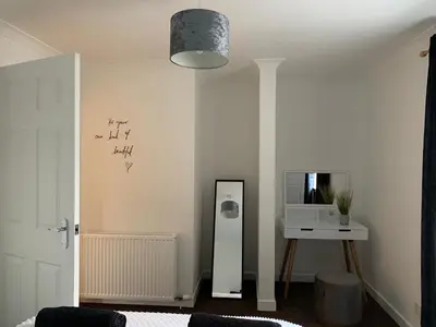 a room with a mirror and a table with a microwave at Dumfries Apartment in Dumfries