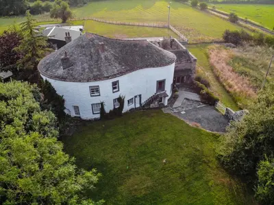 an aerial view of a large white house with a yard at Fiddleback Farm in Wigton