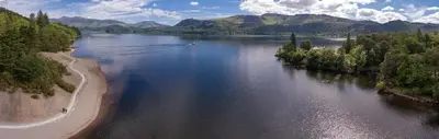 an aerial view of a lake with a boat in it at Brandlehow HOT TUB HIRE AVAILABLE in Portinscale