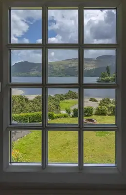 a window with a view of a field of grass at Brandlehow HOT TUB HIRE AVAILABLE in Portinscale