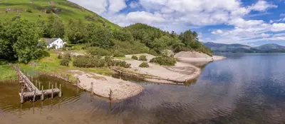 an island in the middle of a body of water at Brandlehow HOT TUB HIRE AVAILABLE in Portinscale