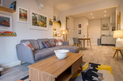 a living room with a couch and a table at Howe Keld 1 Ground floor in Keswick