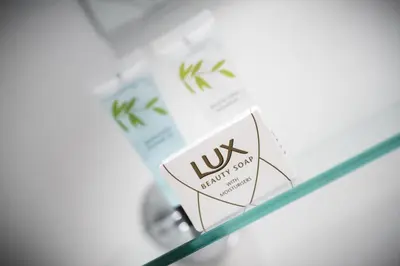 a glass shelf with a sign that reads lux minerals laboratory at The Dwelling Place in Irvine