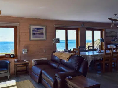 a living room with a couch and a table at Seal Rocks in Lendalfoot