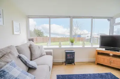 a living room with a couch and a television at The Wigwam in Dumfries