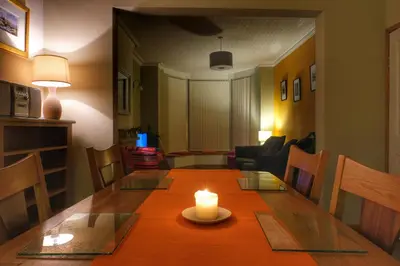 a dining room table with a candle on top of it at Felltop Cottage in Keswick