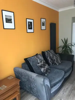 a living room with a couch and a table at Felltop Cottage in Keswick