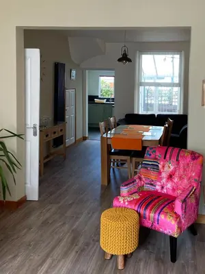 a living room with a table and a chair at Felltop Cottage in Keswick