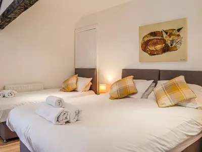 a bedroom with two beds with towels on them at Mount Farm - The Stable in Harker