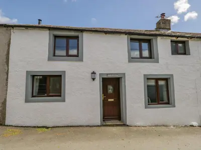 a white house with windows and a door at Ashness in Keswick