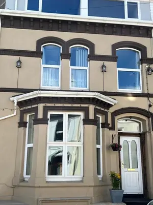 a house with white windows and a door at Sea-Renity - Self Catering Holiday Let in Douglas