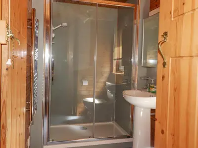 a shower in a bathroom with a sink and a toilet at Robin's Nest in Keswick