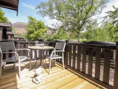 a patio with a table and chairs on a deck at Robin's Nest in Keswick