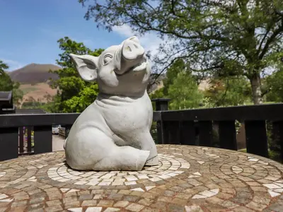 a statue of a dog sitting on a table at Robin's Nest in Keswick