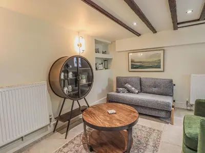 a living room with a couch and a table at Wisteria in Ambleside