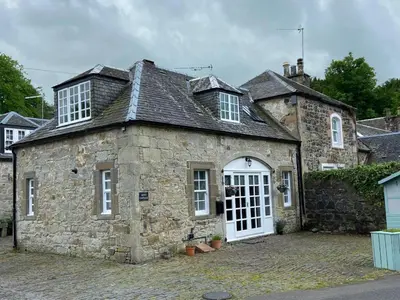 an old stone building with a white door at House - Sleeps 4 Pet Friendly & Free Parking in Symington