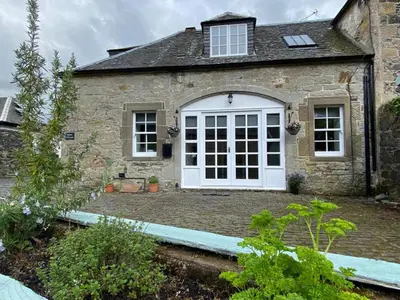a stone house with a white door at House - Sleeps 4 Pet Friendly & Free Parking in Symington