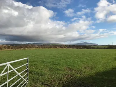 a fence in a field with a green field at Dale View bed & breakfast in Holmrook