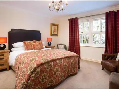 a bedroom with a large bed and a window at Stone Beck in Ambleside