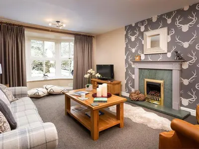 a living room with a living room with a fireplace at Stone Beck in Ambleside
