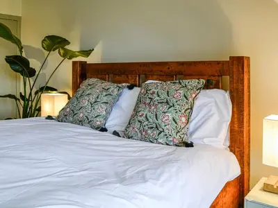 a bed with two pillows on top of it at 9A Church Place in Kirkcudbright