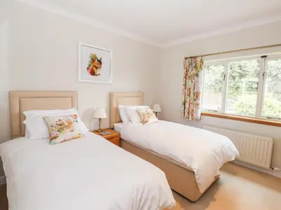 a bedroom with two beds and a window at Edencroft in Penrith