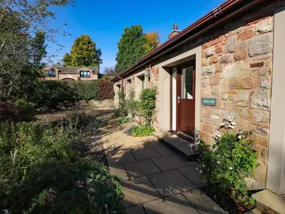 a brick building with a door on the side of it at Edencroft in Penrith