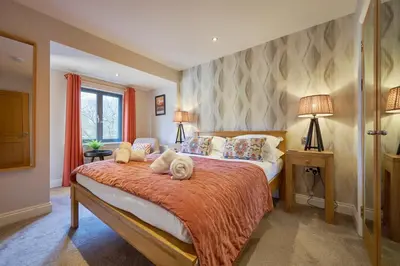 a bedroom with a large bed and a window at Riverside Park 6 in Keswick