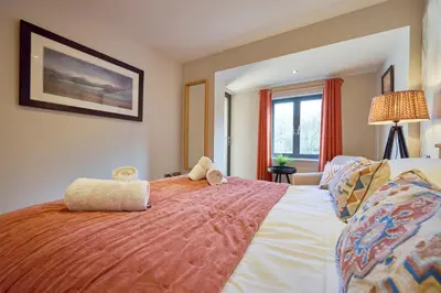 a bedroom with a large bed with two stuffed animals on it at Riverside Park 6 in Keswick