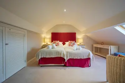 a bedroom with a large bed with a red headboard at Riverside Park 6 in Keswick