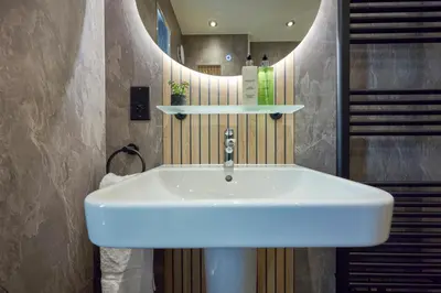 a white sink in a bathroom with a mirror at Riverside Park 6 in Keswick
