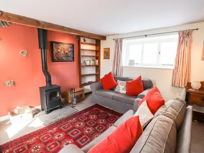 a living room with a couch and a stove at One Town End in Penrith