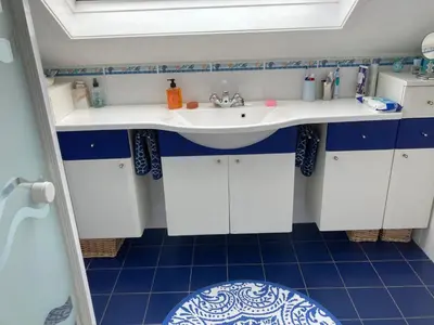 a bathroom with a sink and a blue tiled floor at Rose Cottage in Prestwick