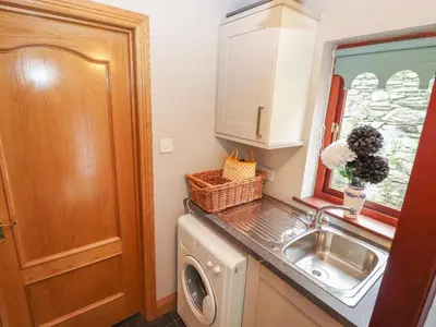 a kitchen with a sink and a washing machine at Beech Nook in Keswick