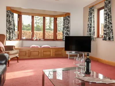 a living room with a flat screen tv and a couch at Beech Nook in Keswick