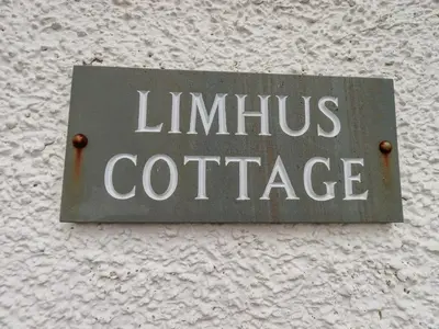 a sign on the side of a building that reads limius coffee at Limhus Cottage in Keswick