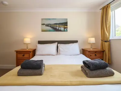 a bedroom with a large bed with two night stands at Inglewood in Keswick