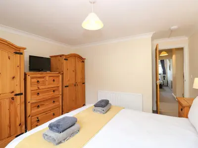 a bedroom with a bed with two towels on it at Inglewood in Keswick