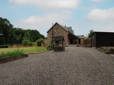 a house with a gravel driveway at Lucys cottage in Canonbie