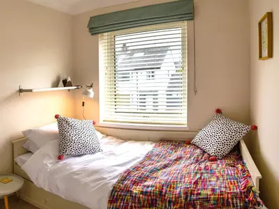 a bed with two pillows and a window in a room at Pooley Howe in Keswick