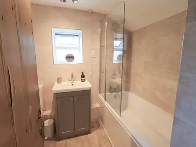 a bathroom with a sink and a shower at Squirrel Cottage in Keswick