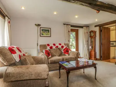 a living room with two couches and a coffee table at Poppy Cottage in Penrith