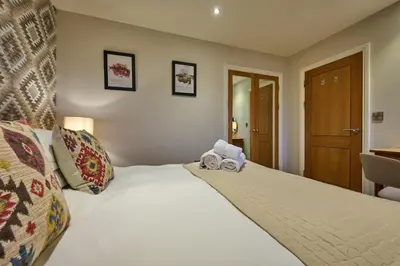 a bedroom with a bed with a stuffed animal on it at Riverside Park 5 in Keswick